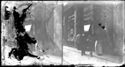 Un uomo e una donna con un bambino a passeggio, in direzione opposta, davanti ad un negozio di strumenti di precisione e un uomo che guarda la vetrina: tratto di via Rizzoli contiguo alla piazza di porta Ravegnana: Bologna