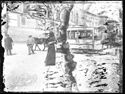 Una donna, due uomini e il passaggio del tramway a cavallo numero 76 davanti al Palazzo Comunale: piazza del Nettuno: Bologna
