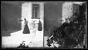 Una donna a passeggio e un bambino e un sacerdote davanti alle buche delle lettere dell’ufficio delle regie poste, nell’ala destra del Palazzo Comunale in piazza del Nettuno: Bologna