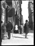 Due uomini vicino al lampione, un uomo di profilo con la sigaretta in bocca e due gruppetti di persone davanti al portico della Gabella in via dell’Indipendenza: prospetto della via dell’Indipendenza: Bologna