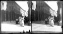 Una donna a passeggio che guarda l’obiettivo fotografico e un gruppo di persone davanti alla cattedrale metropolitana di San Pietro in via dell’Indipendenza: prospetto del palazzo del Seminario arcivescovile: Bologna